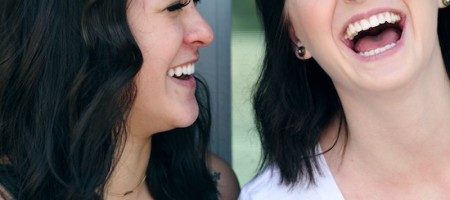 Two women with dark hair laughing. | PC: Sharon McCutcheon on UnSplash