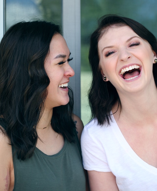 Two women with dark hair laughing. | PC: Sharon McCutcheon on UnSplash