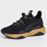 Shown: Puma Defy Sparkle Sneakers in black and gold