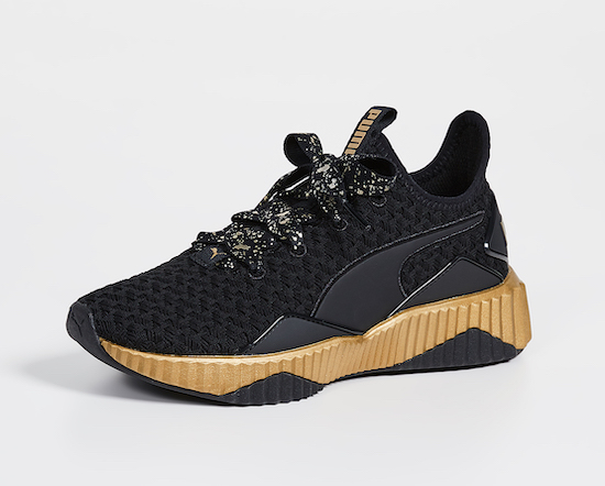 Shown: Puma Defy Sparkle Sneakers in black and gold